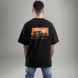 "Black oversized t-shirt featuring a vintage Ford Mustang graphic on the back with an orange grunge background – worn by a male model facing away."