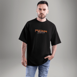 Front view of a black oversized t-shirt with a small Ford Mustang logo and classic car graphic on the chest – styled with casual jeans.